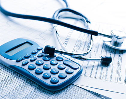 calculator, stethoscope and paperwork